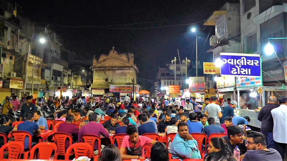 Image of red chairs placed at a street square selling food