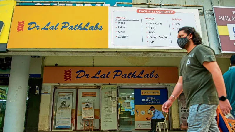 A man walks past a Dr Lal PathLabs outlet