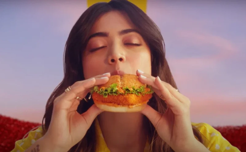An Indian girl enjoys a burger