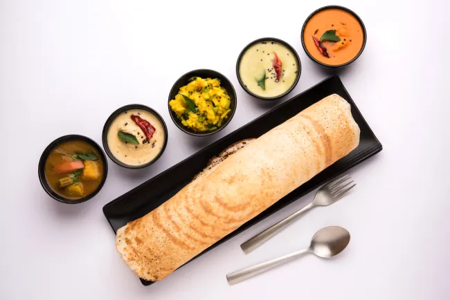 Masala dosa is a South Indian meal served with sambhar and coconut chutney.
